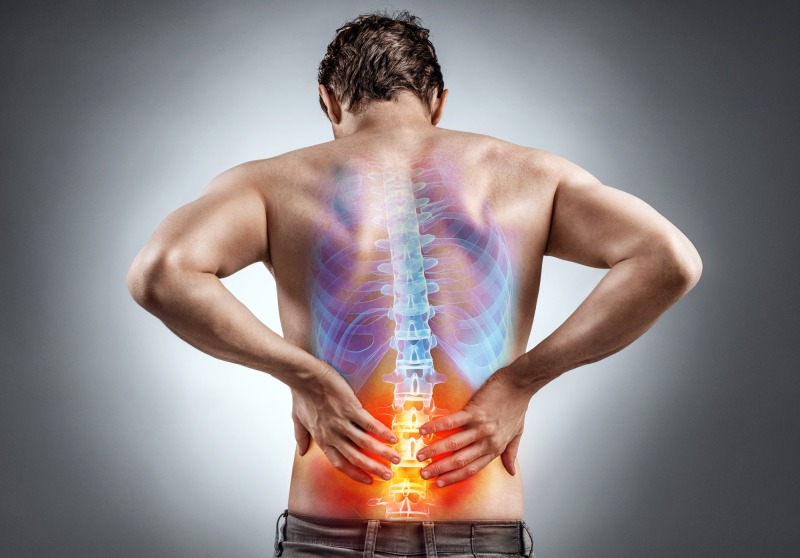 Lower back pain. Man holding his back in pain. Medical concept.